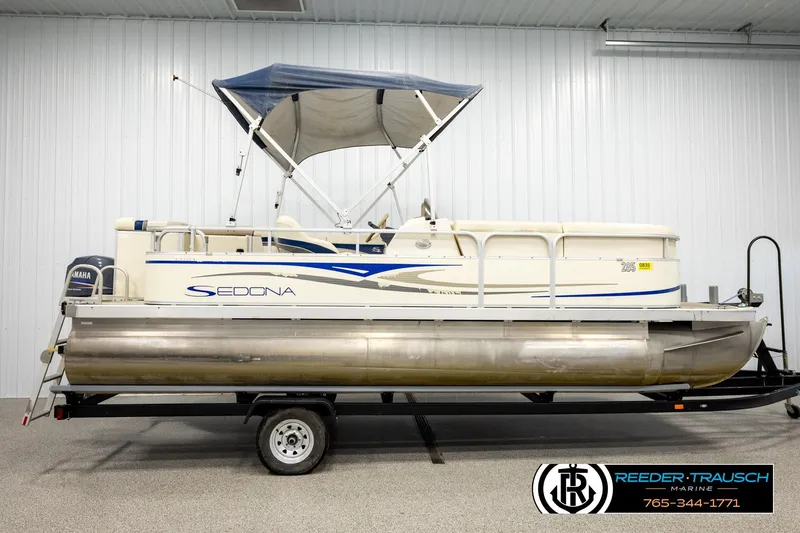 Slide: The Image of 2008 Sedona 20 CR pontoon boat with canopy on trailer in indoor showroom. - 5
