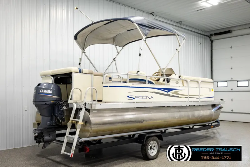 Slide: The Image of 2008 Sedona 20 CR pontoon boat with Yamaha outboard motor in a garage setting. - 6