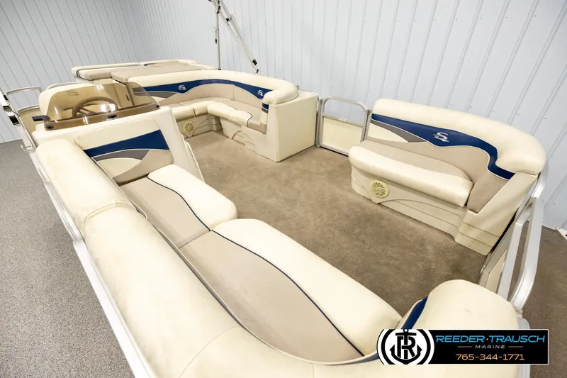 Slide: The Image of 2008 Sedona 20 CR pontoon boat interior with beige and blue seating. - 9