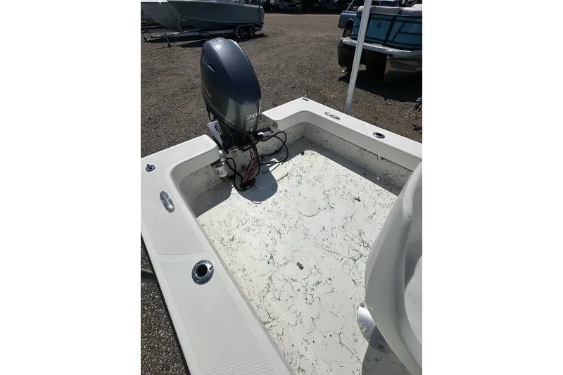 Slide: The Image of 2007 PANGA MARINE 18 boat with outboard motor in a gravel lot. - 11