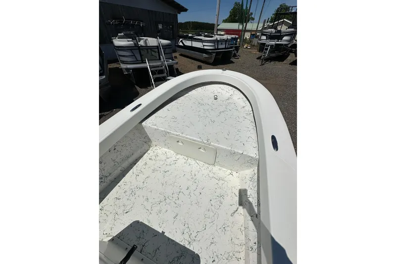 Slide: The Image of 2007 Panga Marine 18 boat interior with white speckled flooring, parked outdoors. - 15