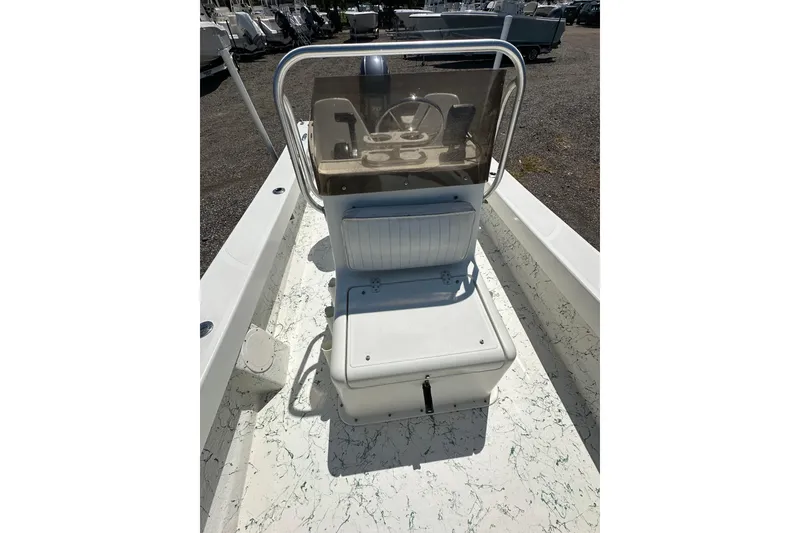 Slide: The Image of 2007 PANGA MARINE 18 boat interior with console and seating, parked outdoors. - 16