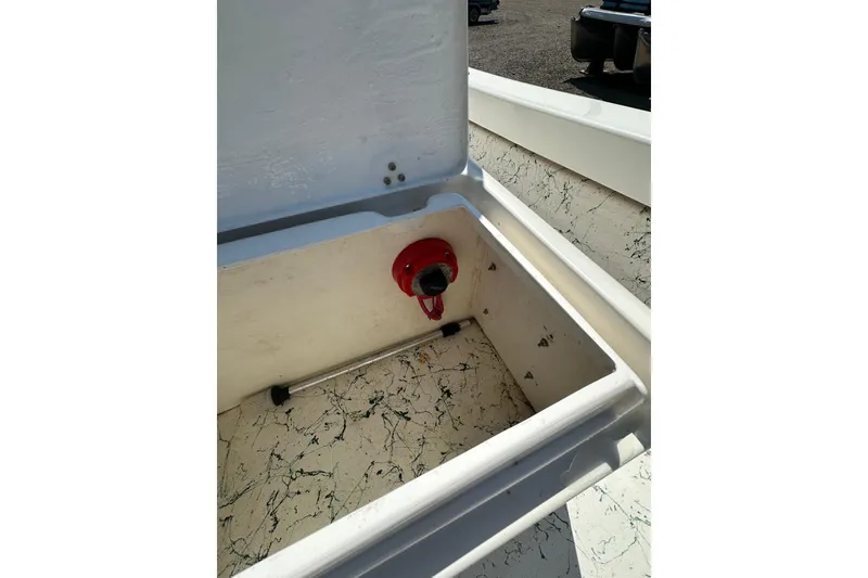 Slide: The Image of 2007 Panga Marine 18 boat compartment with red valve and textured interior. - 18