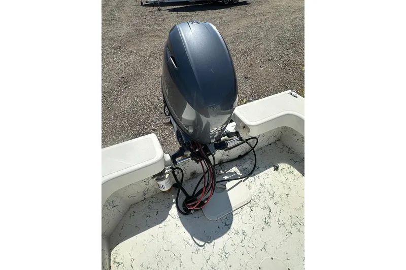 Slide: The Image of 2007 Panga Marine 18 boat with outboard motor in a gravel lot. - 21