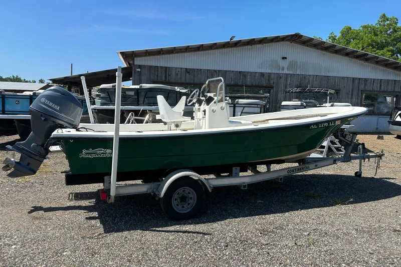 Slide: The Image of 2007 Panga Marine 18 boat on trailer with Yamaha outboard motor, parked outdoors. - 7