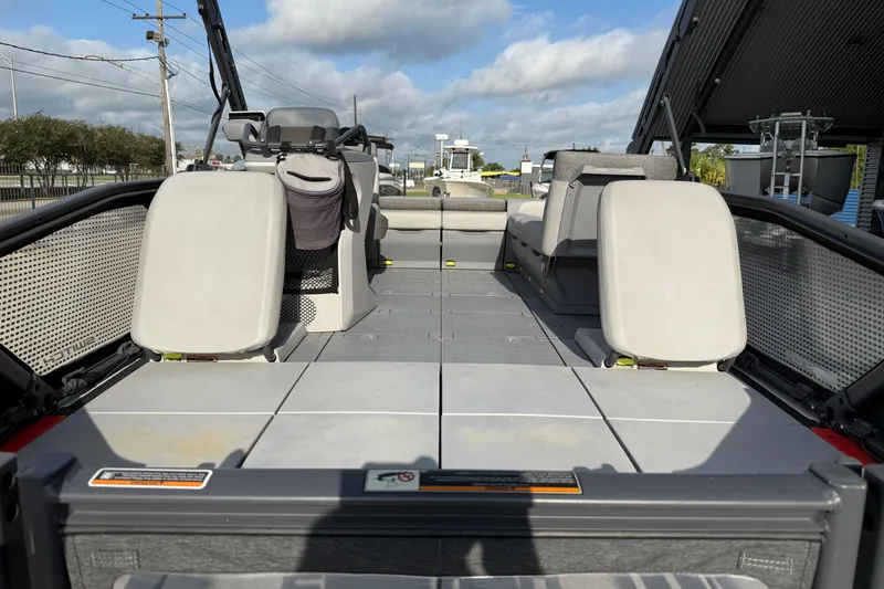 Slide: The Image of 2023 Sea-Doo Switch Sport 18 interior with seating and open deck layout. - 11