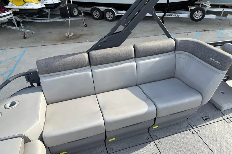 Slide: The Image of 2023 Sea-Doo Switch Sport 18 boat seating area with gray upholstery and cup holder. - 17