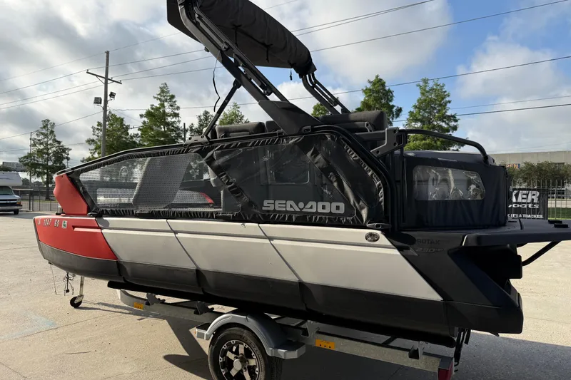 Slide: The Image of 2023 Sea-Doo Switch Sport 18 pontoon boat on trailer, parked outdoors. - 3