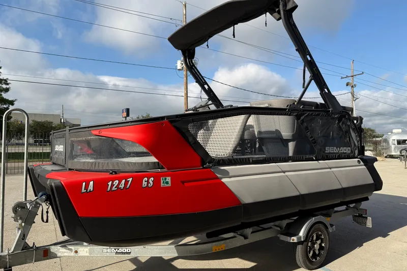 Slide: The Image of 2023 Sea-Doo Switch Sport 18 on trailer, featuring sleek red and black design. - 6