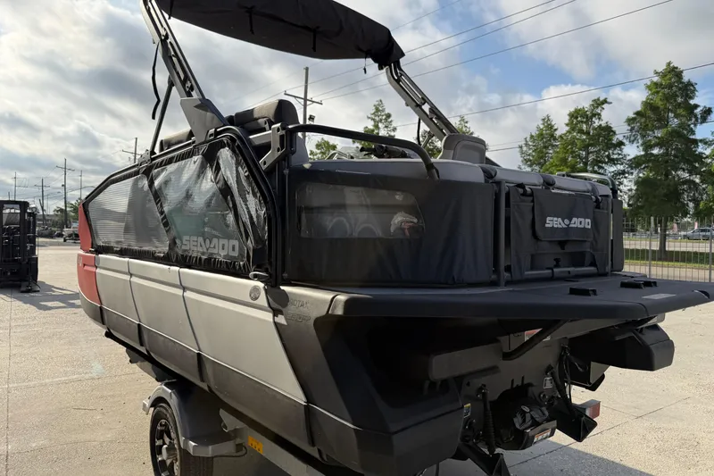 Slide: The Image of 2023 Sea-Doo Switch Sport 18 pontoon boat with canopy, parked outdoors. - 8