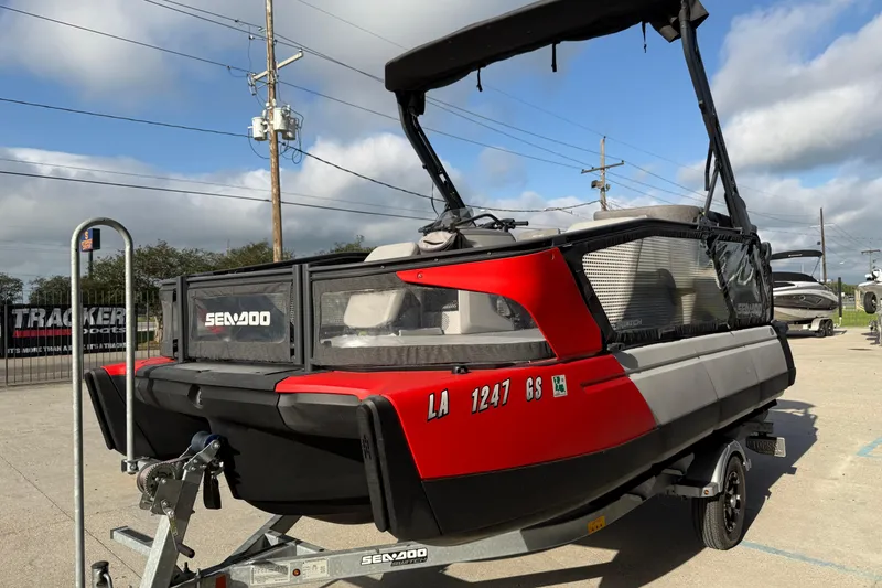 Slide: The Image of 2023 Sea-Doo Switch Sport 18 pontoon boat on trailer, parked outdoors. - 9