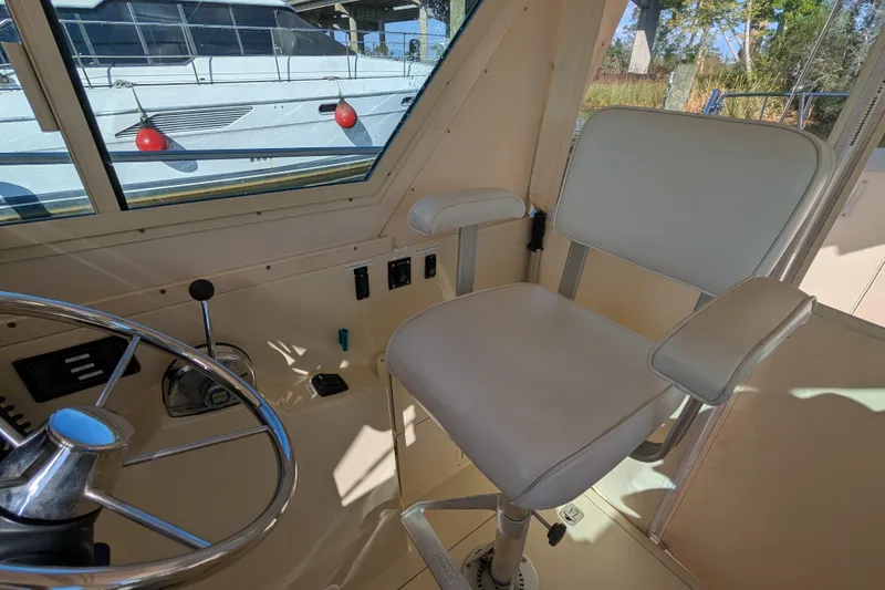 Slide: The Image of Interior of 2004 Albin 30 Family Cruiser, featuring helm seat and steering wheel. - 19