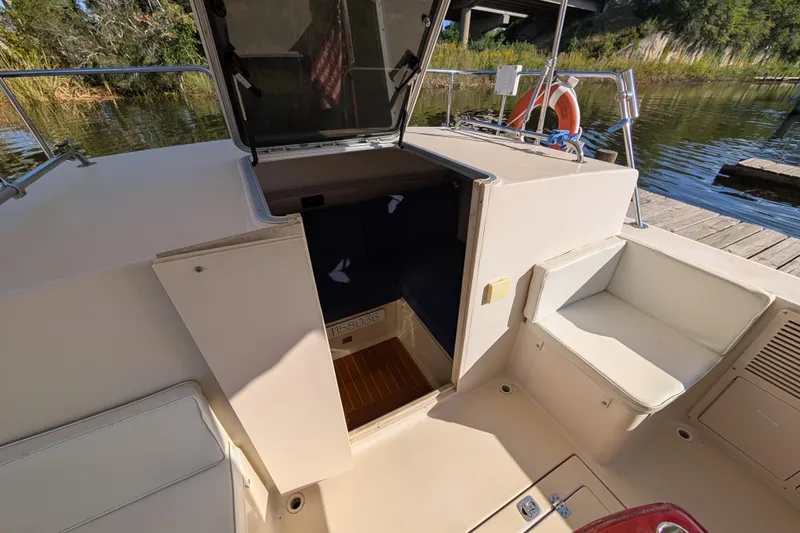 Slide: The Image of 2004 Albin 30 Family Cruiser interior view with open hatch and seating area. - 26