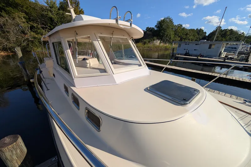 Slide: The Image of 2004 Albin 30 Family Cruiser docked at marina, sunny day, surrounded by trees and water. - 29