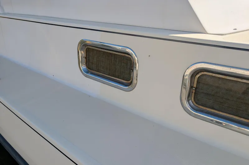 Slide: The Image of 2004 Albin 30 Family Cruiser boat windows with chrome frames. - 33