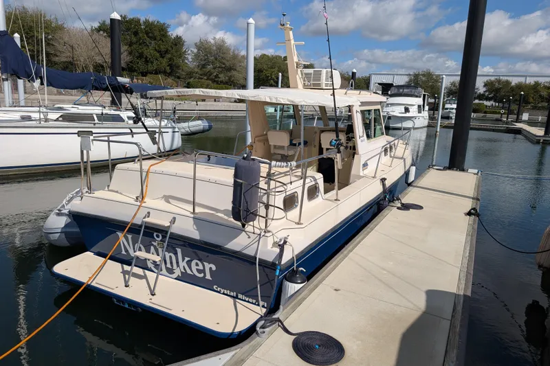 Slide: The Image of 2004 Albin 30 Family Cruiser docked at marina under blue sky. - 42