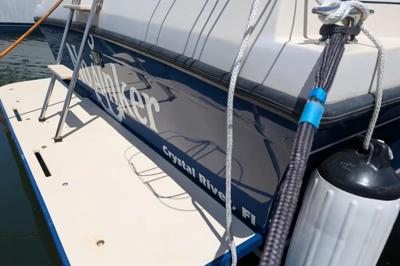 Slide: The Image of 2004 Albin 30 Family Cruiser docked, featuring a swim platform and ladder in Crystal River, FL. - 44