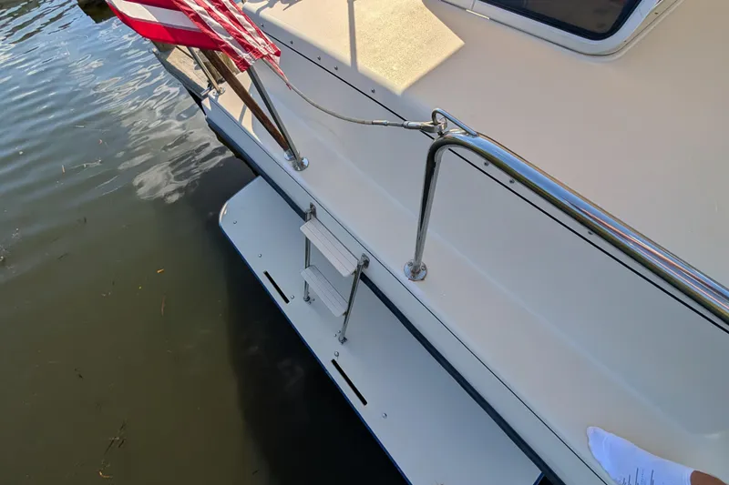 Slide: The Image of 2004 Albin 30 Family Cruiser stern with swim platform and American flag. - 45