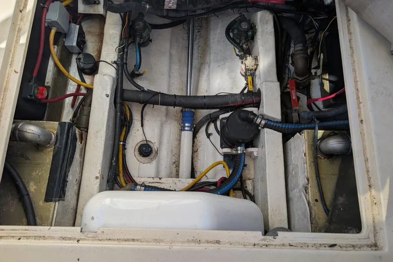 Slide: The Image of Engine compartment of a 2004 Albin 30 Family Cruiser, showing wiring and mechanical components. - 57