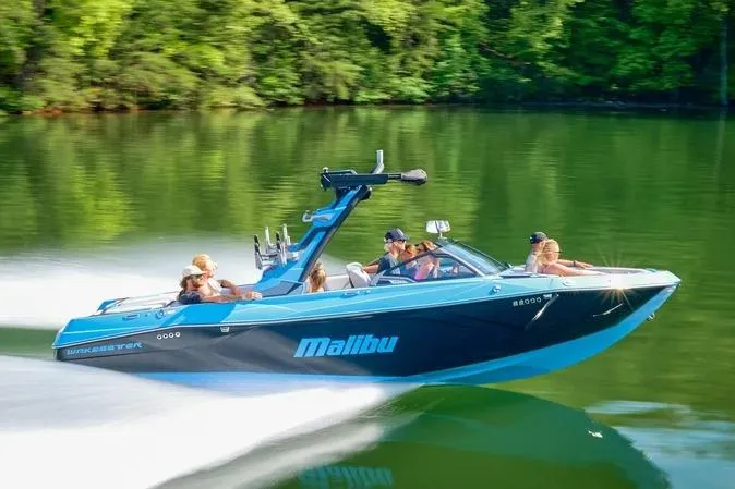 The Image of Manufacturer Provided Image: 2026 Malibu Wakesetter 23 LSV speeding on a serene lake with passengers enjoying the ride. - 0