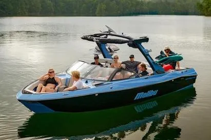 Slide: The Image of Manufacturer Provided Image: 2026 Malibu Wakesetter 23 LSV on a serene lake with passengers enjoying the ride. - 2