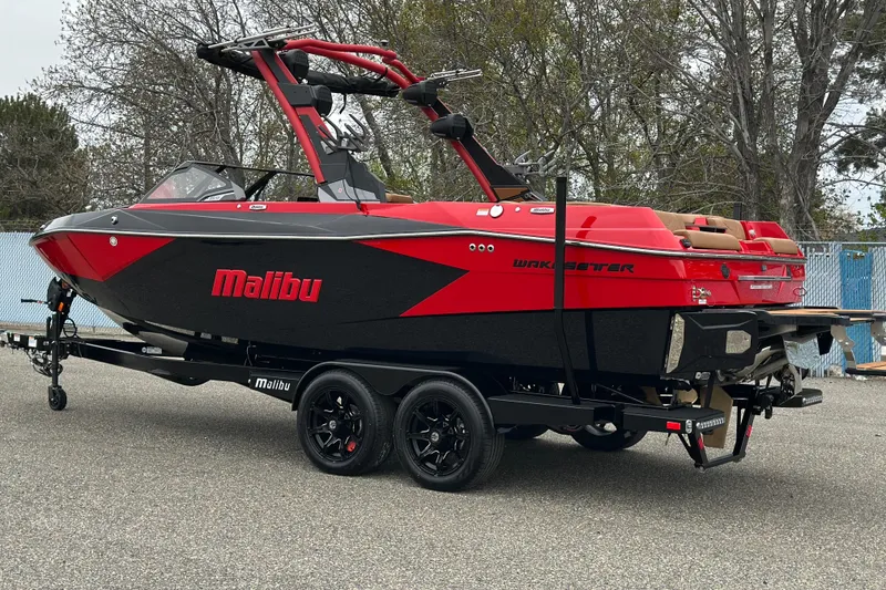 The Image of 2026 Malibu Wakesetter 23 LSV boat in red and black on a trailer. - 9