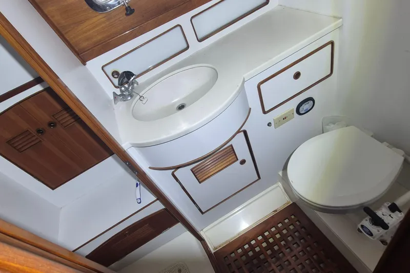 Slide: The Image of 1990 Little Harbor Express yacht bathroom with wooden accents and compact design. - 10