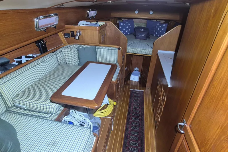 Slide: The Image of Interior of a 1990 Little Harbor Express yacht with cozy seating and wooden finishes. - 11