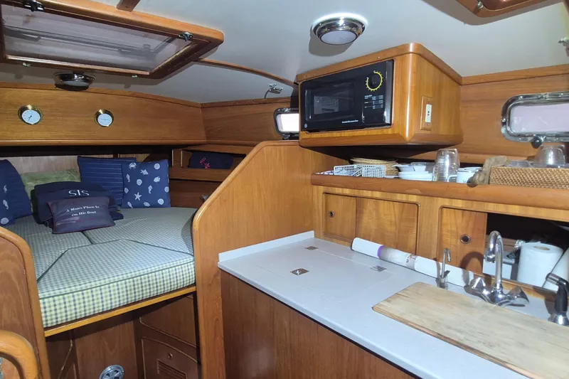 Slide: The Image of Cozy 1990 Little Harbor Express yacht interior with kitchenette and sleeping area. - 12