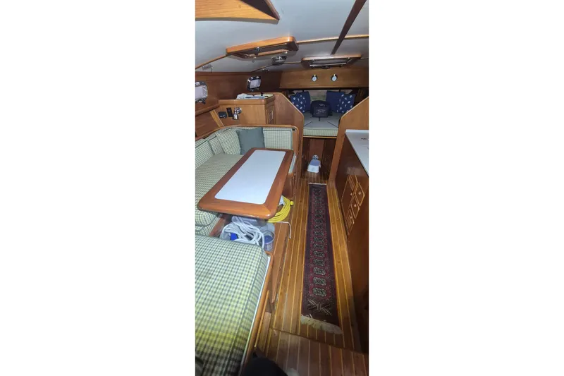 Slide: The Image of Interior of 1990 Little Harbor Express yacht with cozy seating and wooden finishes. - 16