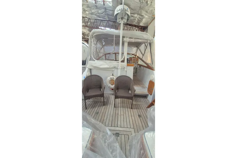Slide: The Image of 1990 Little Harbor Express yacht interior with wicker chairs and wooden deck. - 17
