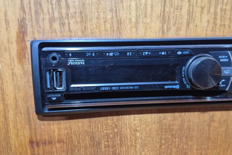 Slide: The Image of Alpine CD receiver with USB port on a wooden panel, Little Harbor Express 1990. - 23