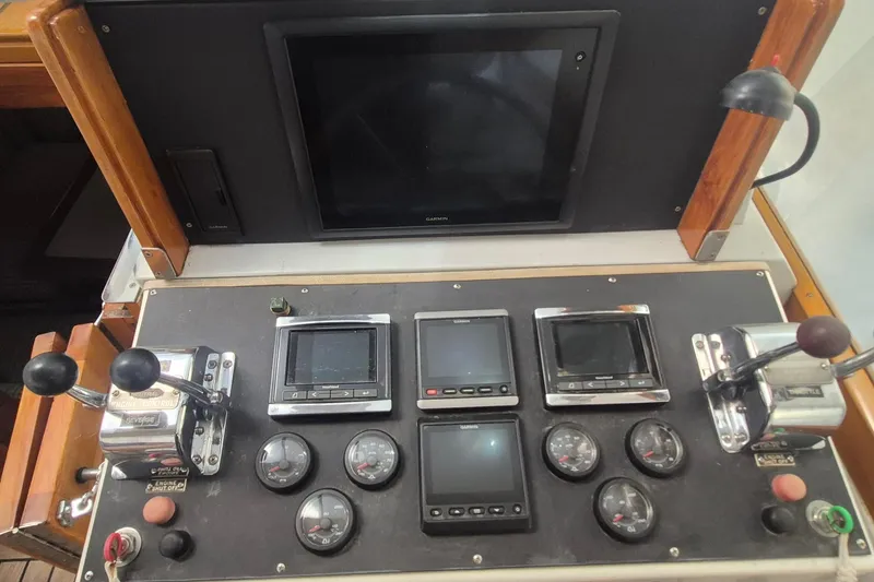 Slide: The Image of Control panel of a 1990 Little Harbor Express boat with gauges and screens. - 28