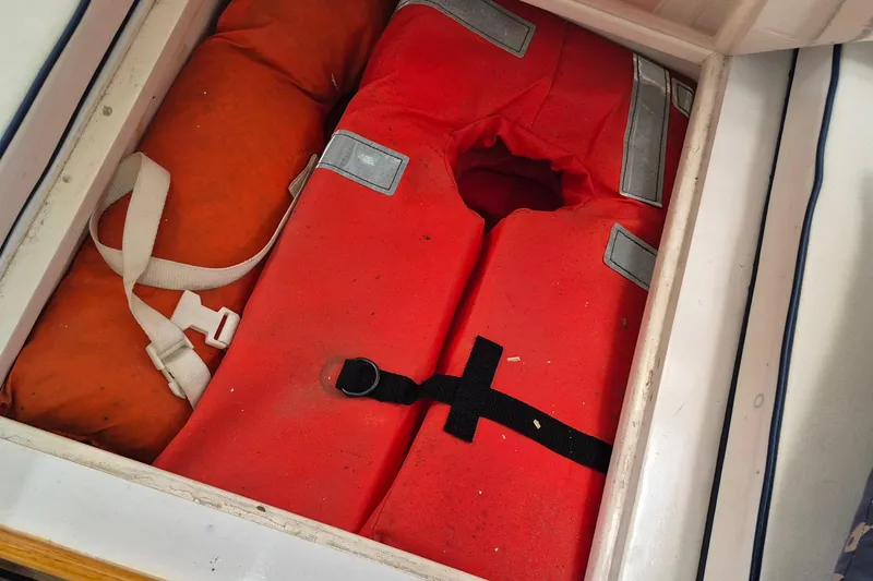 Slide: The Image of Life jackets stored in a compartment on a 1990 Little Harbor Express boat. - 30