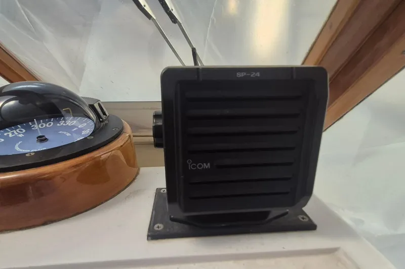 Slide: The Image of Compass and Icom speaker on 1990 Little Harbor Express boat dashboard. - 33