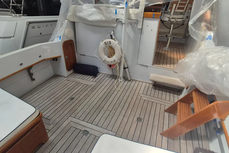 Slide: The Image of 1990 Little Harbor Express boat interior with wooden deck and life preserver. - 4