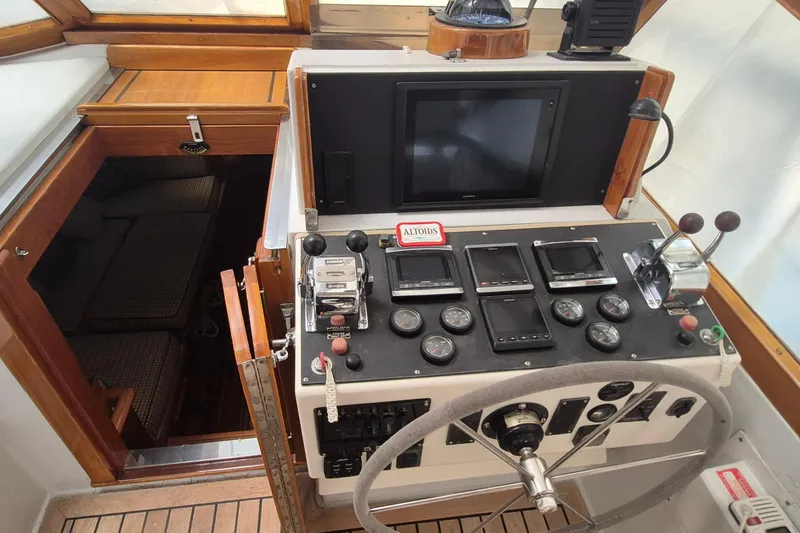 Slide: The Image of 1990 Little Harbor Express boat helm with navigation instruments and wooden interior. - 8