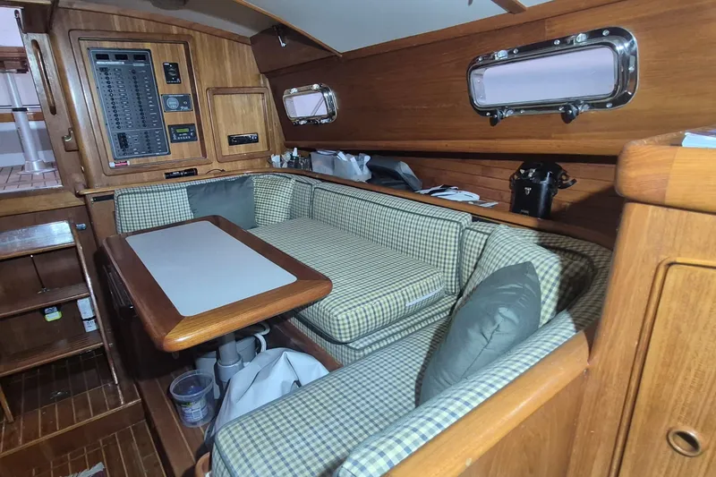 Slide: The Image of Interior of a 1990 Little Harbor Express yacht with cozy seating and wooden finishes. - 9