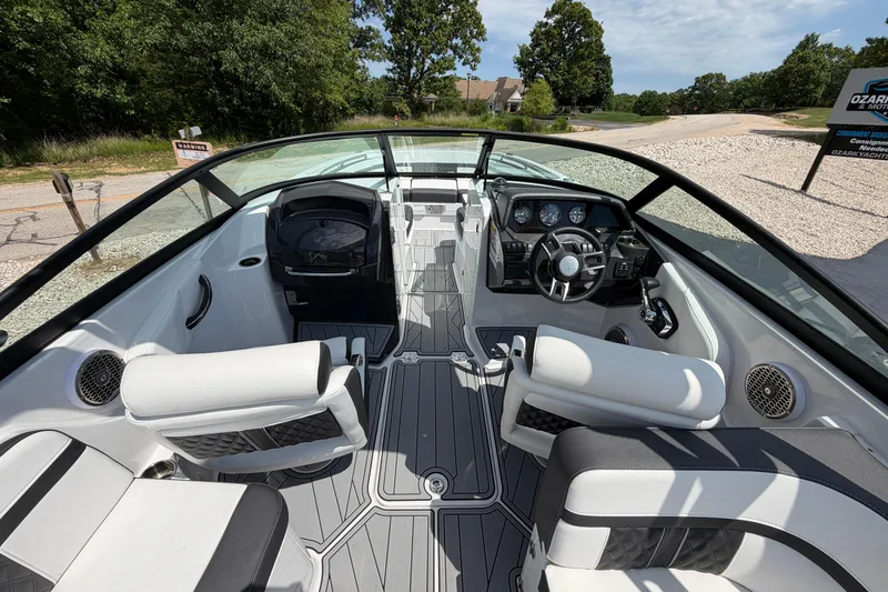 Slide: The Image of Interior view of a 2025 Monterey M6 boat, featuring sleek seating and modern dashboard. - 13