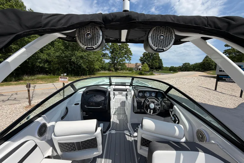 Slide: The Image of Interior view of a 2025 Monterey M6 boat with modern dashboard and seating. - 14
