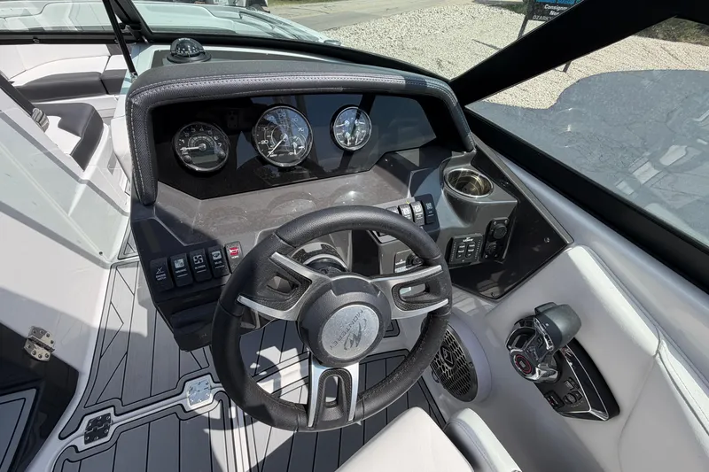 Slide: The Image of 2025 Monterey M6 boat dashboard with steering wheel and control panel. - 18