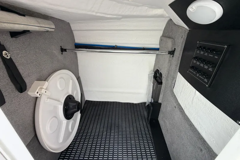 Slide: The Image of Interior of 2025 Monterey M6 boat storage compartment with equipment and control panel. - 19