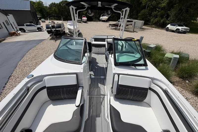 Slide: The Image of 2025 Monterey M6 boat interior with sleek seating and modern design in outdoor setting. - 22