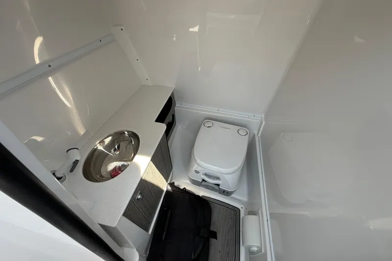 Slide: The Image of Compact bathroom in 2025 Monterey M6 boat with sink and portable toilet. - 23