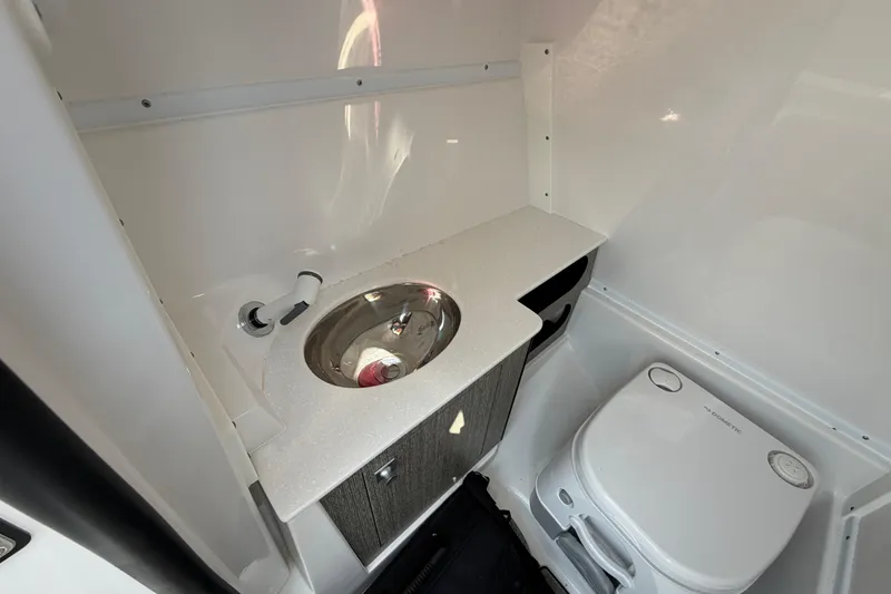 Slide: The Image of Compact bathroom in 2025 Monterey M6 boat with sink and toilet. - 24