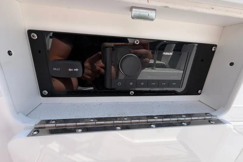Slide: The Image of Control panel of a 2025 Monterey M6 boat featuring a Fusion audio system. - 26