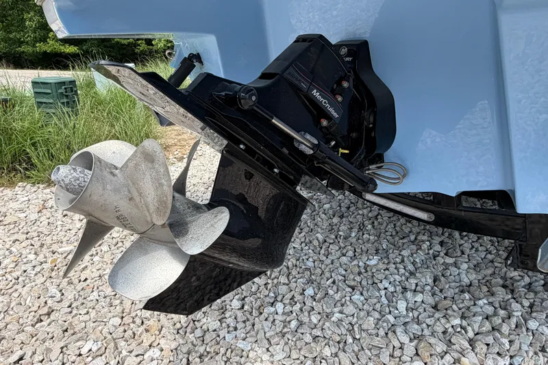 Slide: The Image of 2025 Monterey M6 boat with MerCruiser outdrive and propeller on gravel surface. - 6