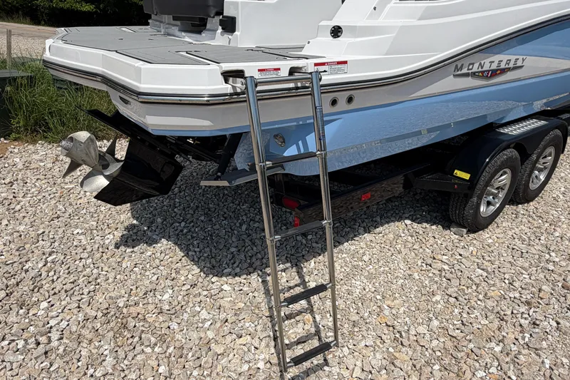 Slide: The Image of 2025 Monterey M6 boat on trailer with ladder and dual propellers. - 8