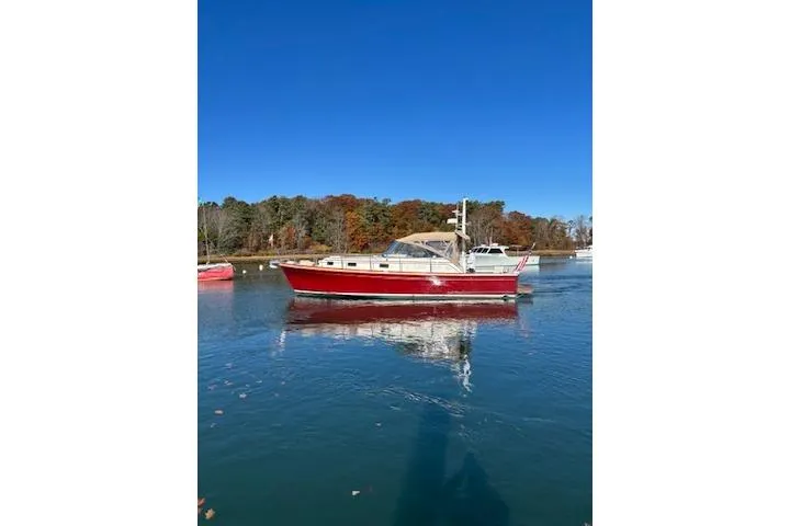 The Image of 1998 Grand Banks 38 Eastbay EX boat on calm water, clear blue sky background. - 1