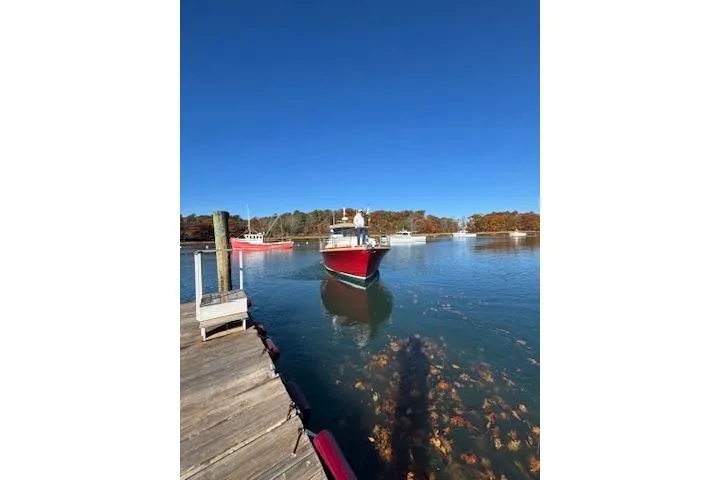Slide: The Image of Red 1998 Grand Banks 38 Eastbay EX boat approaching dock on a clear day. - 10